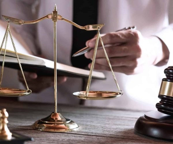 gavel-on-wooden-table-and-lawyer-or-judge-working-with-agreement-in-courtroom-theme.jpg